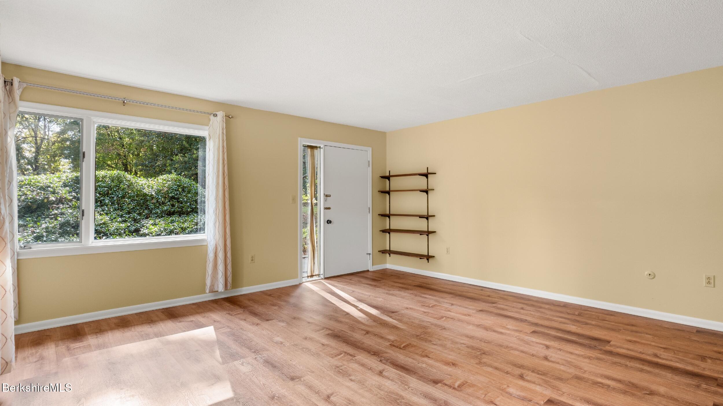 1 Colt Road, Unit 2 Pittsfield, MA 01201 - Photo 5 of 20 a view of an empty room with a window and wooden floor