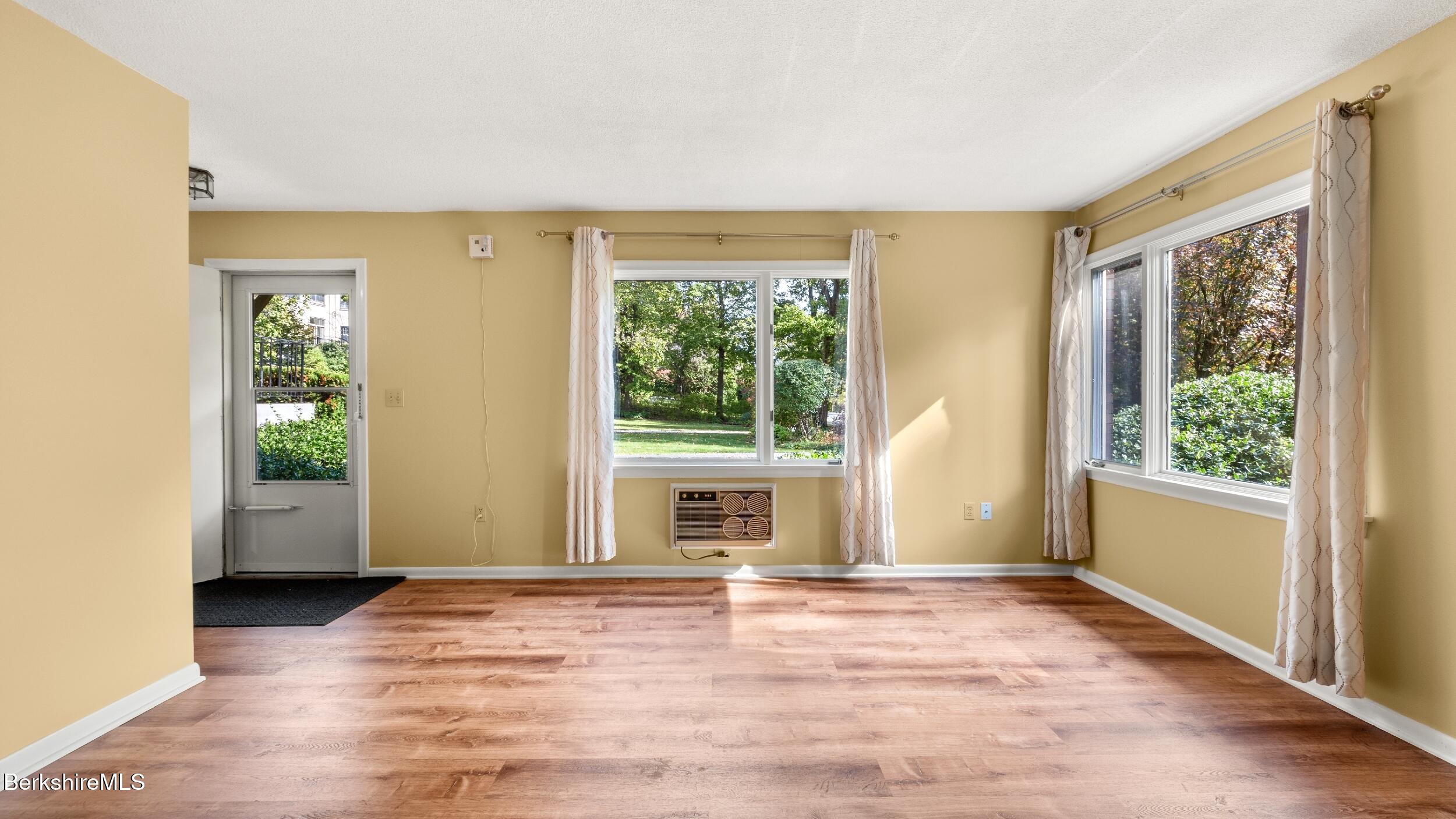 1 Colt Road, Unit 2 Pittsfield, MA 01201 - Photo 6 of 20 a view of an empty room with a window and wooden floor