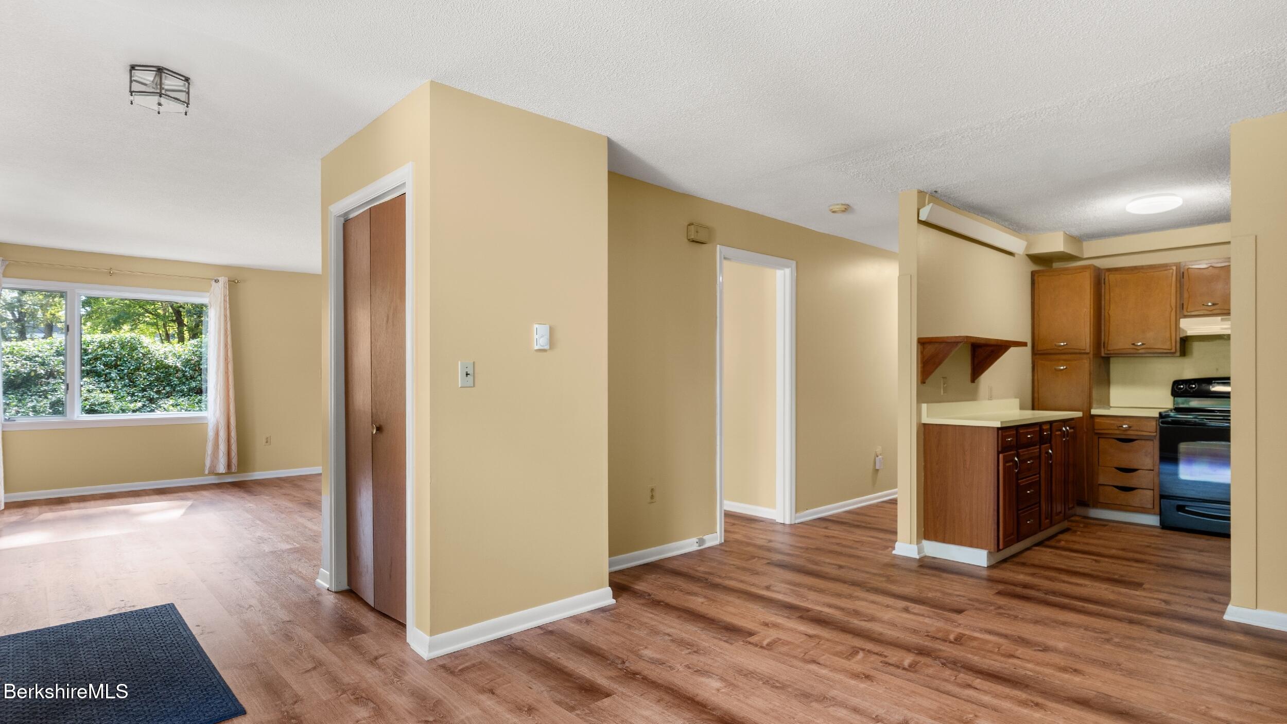 1 Colt Road, Unit 2 Pittsfield, MA 01201 - Photo 7 of 20 a view of a kitchen with wooden floor and a refrigerator