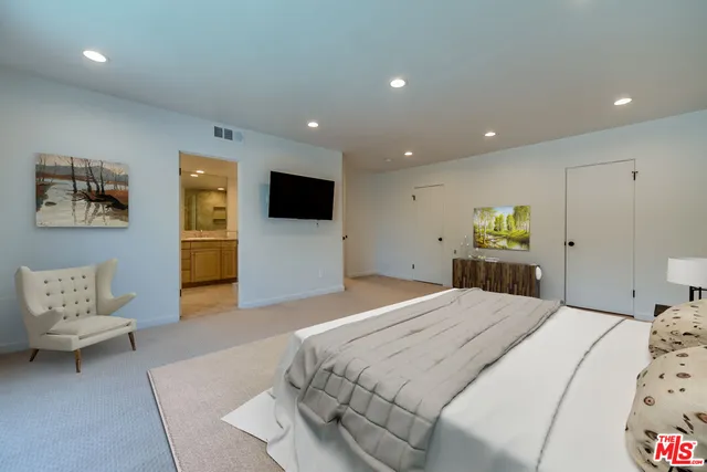 a bedroom with a bed and a couch