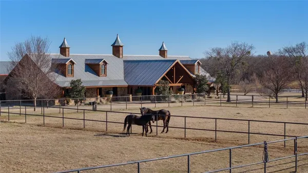 a view of a house with a yard and sitting area