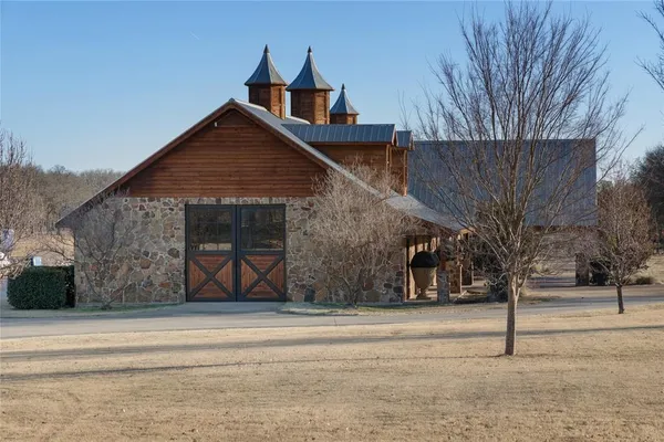 a front view of a house with glass windows and yard