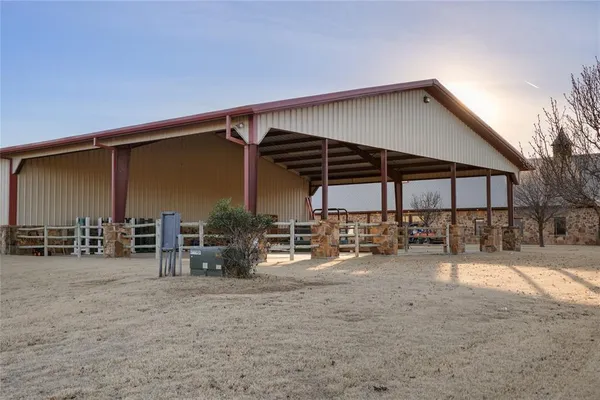 a backyard of a house with large trees and plants