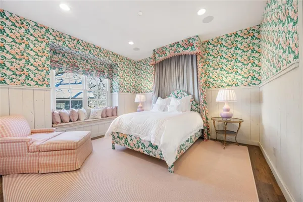 a bedroom with a bed a couch and a chandelier