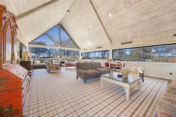 a living room with fireplace furniture and a large window