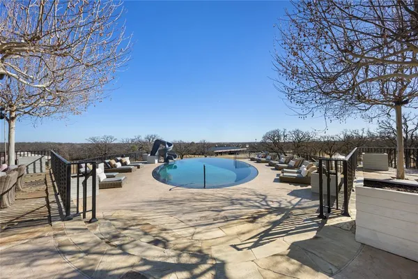 a view of a swimming pool with an outdoor seating and a patio