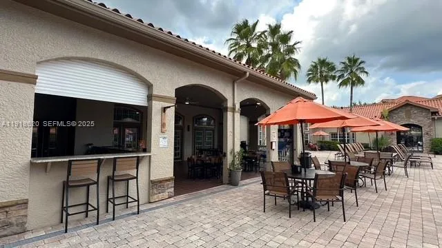 a view of a big yard with plants and large trees