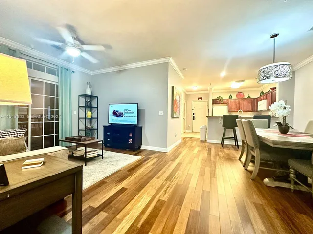 a living room with dining room and wooden floor