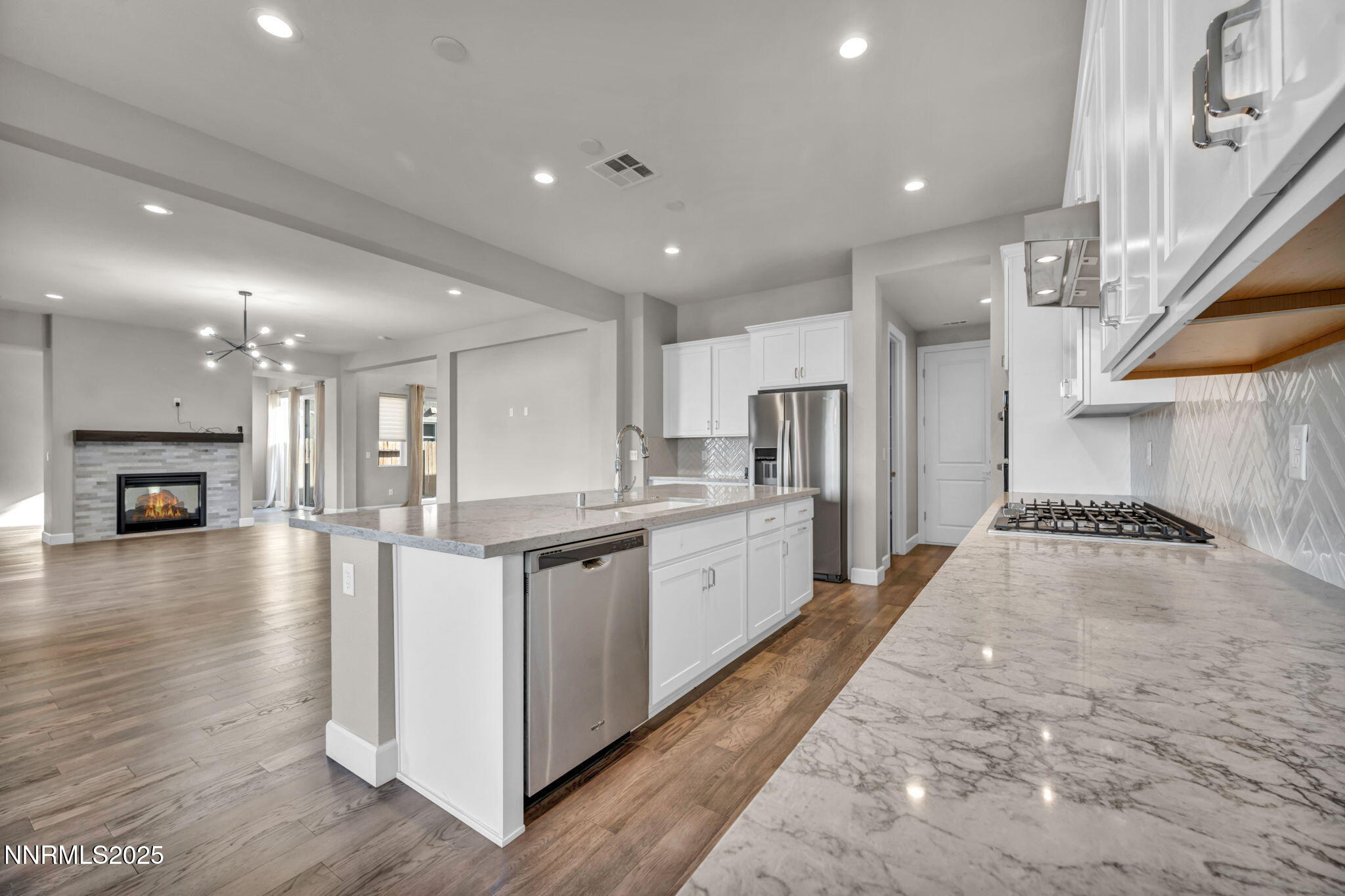 9267 Blue Basin Trail Reno, NV 89521 - Photo 13 of 68 a large kitchen with stainless steel appliances granite countertop a large counter top a stove and a wooden floors