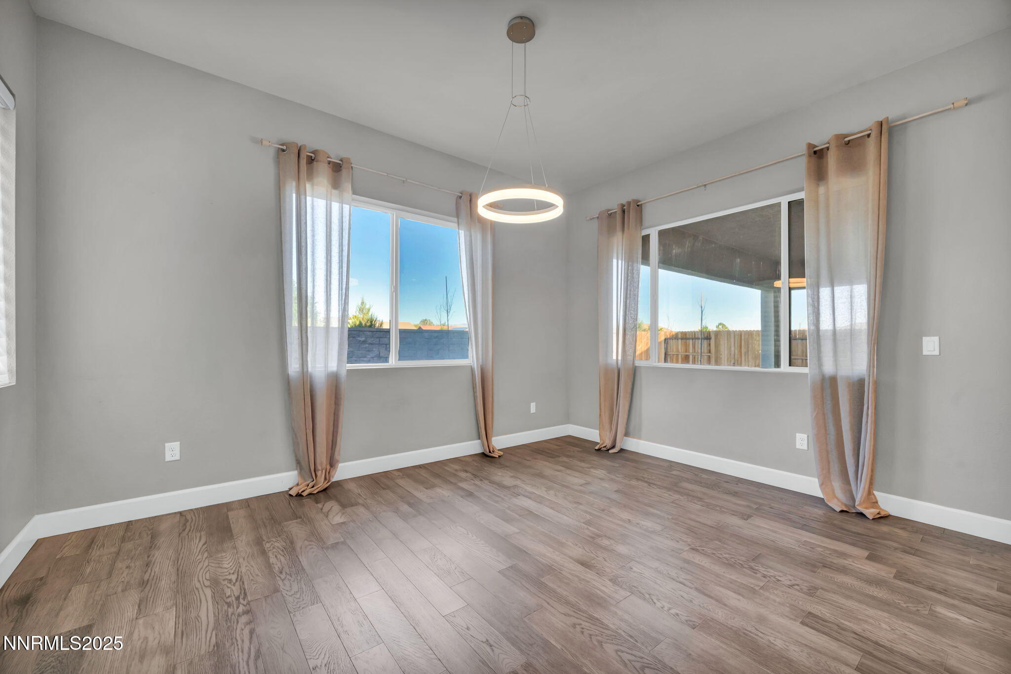 9267 Blue Basin Trail Reno, NV 89521 - Photo 15 of 68 an empty room with wooden floor and windows