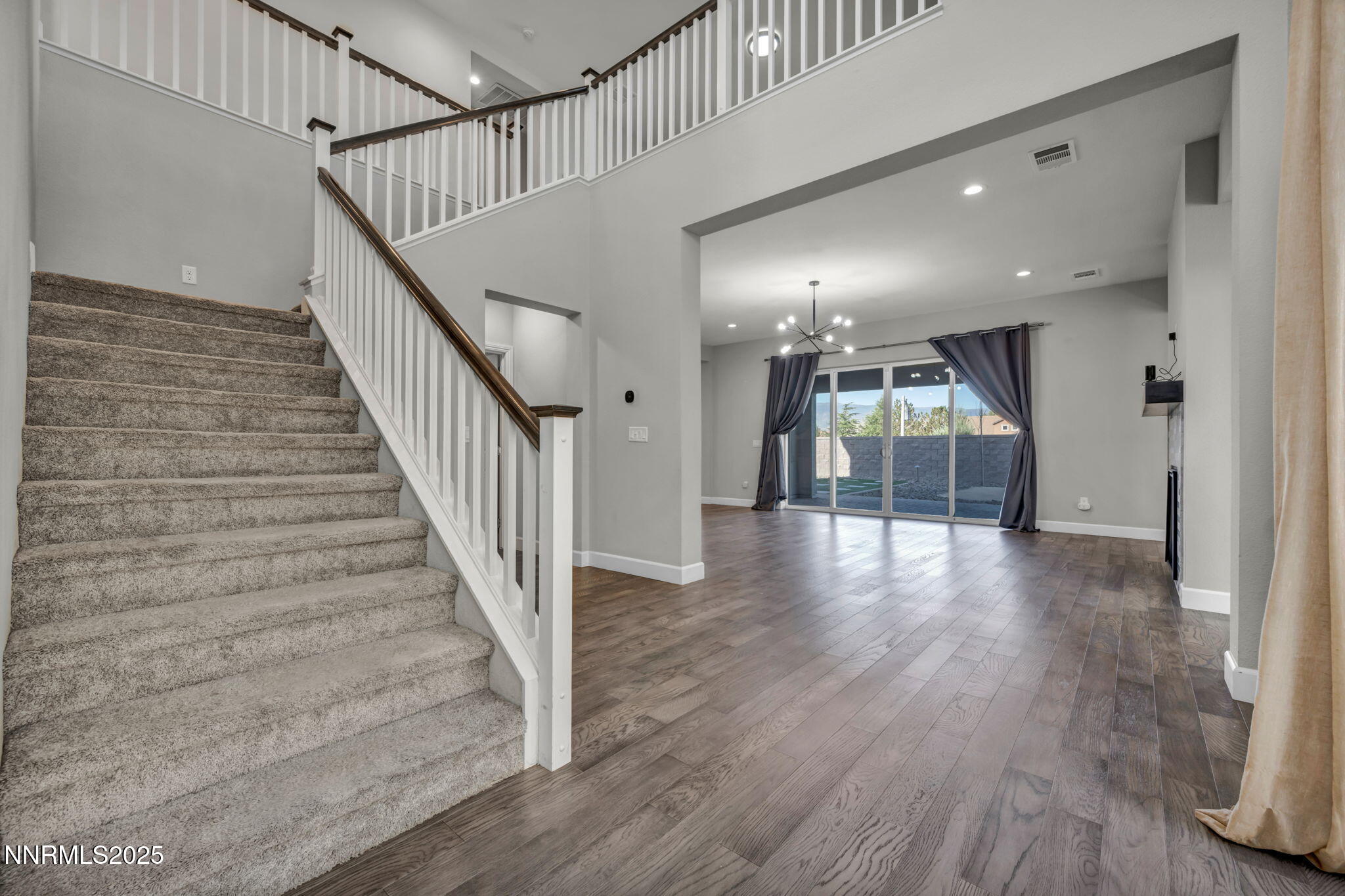 9267 Blue Basin Trail Reno, NV 89521 - Photo 26 of 68 a view of a hallway with wooden floor and staircase