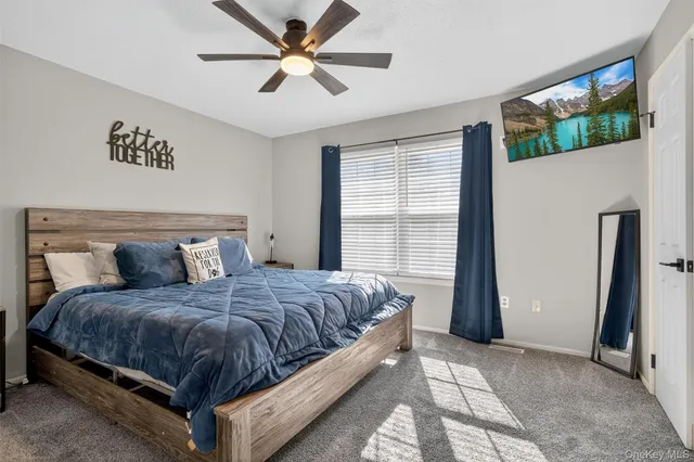 a bedroom with a large bed and a large window
