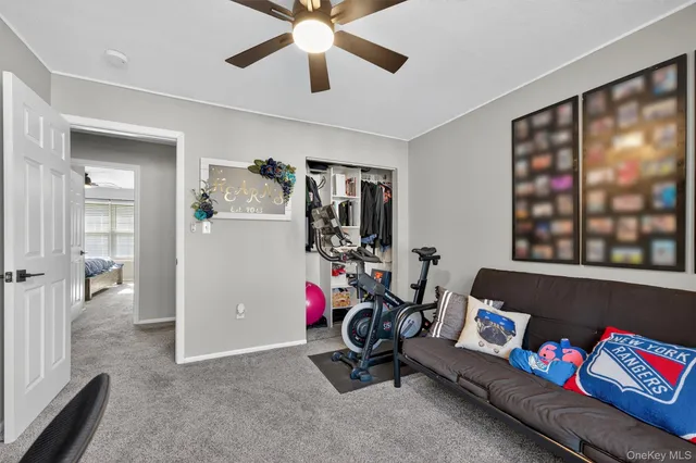 a view of a livingroom with furniture and a ceiling fan