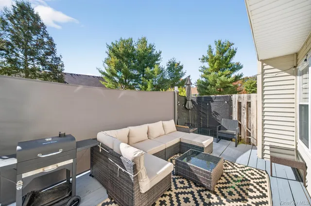 a backyard of a house with table and chairs