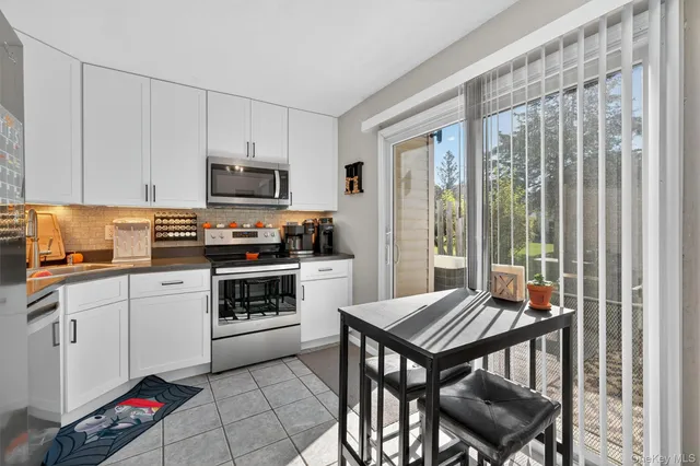 a kitchen with a stove a sink and a refrigerator