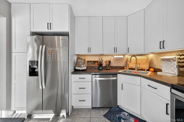 a kitchen with stainless steel appliances granite countertop a refrigerator sink and cabinets