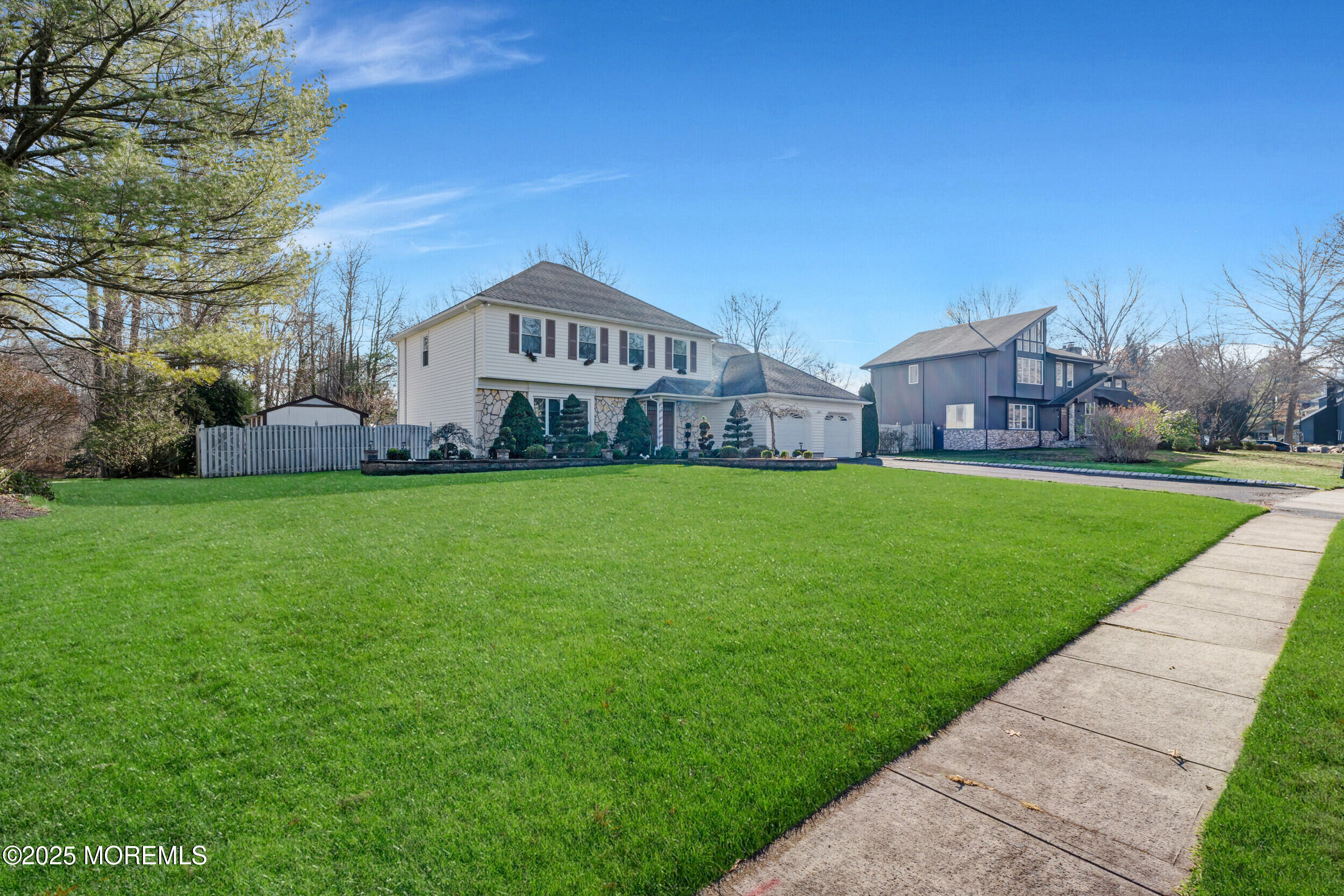 a view of a house with a yard and sitting area