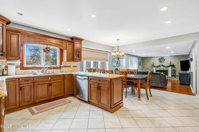 a kitchen with stainless steel appliances granite countertop sink cabinets and wooden floor