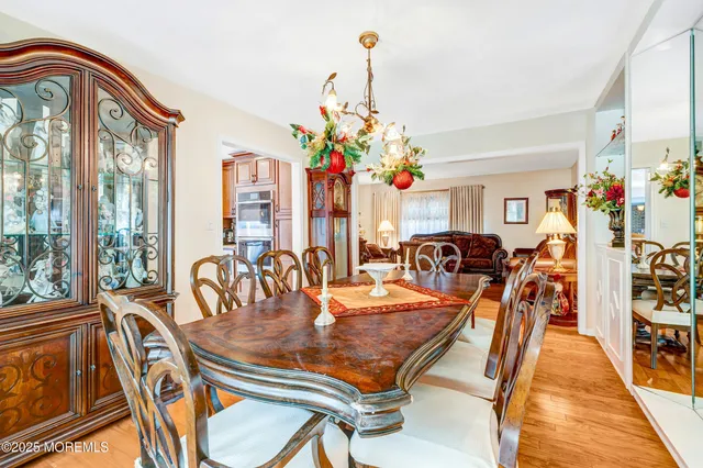 a dining room filled with furniture and chandelier