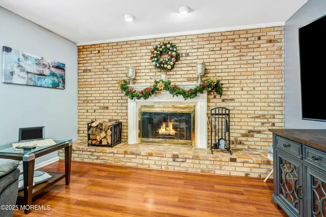 a living room with fireplace furniture and a flat screen tv