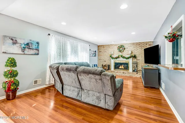 a living room with furniture a flat screen tv and a fireplace