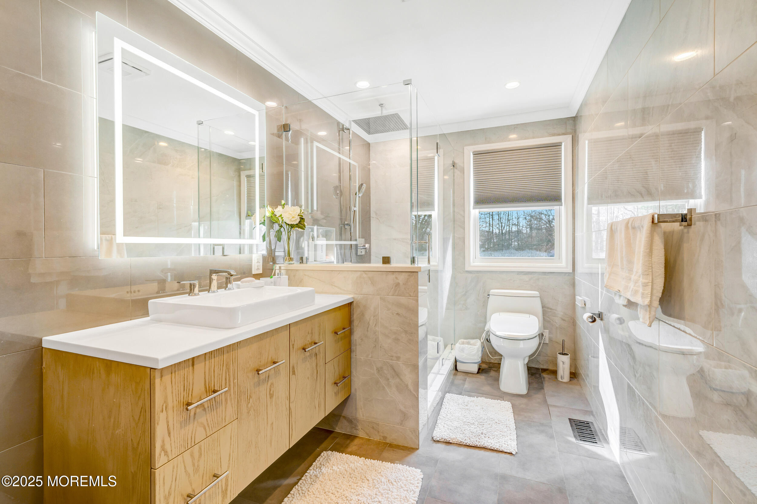 7 Oak Tree Lane Asbury Park, NJ 07712 - Photo 27 of 45 a spacious bathroom with a sink a toilet and a large mirror