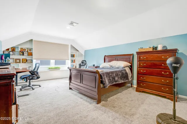 a bedroom with a bed and a desk