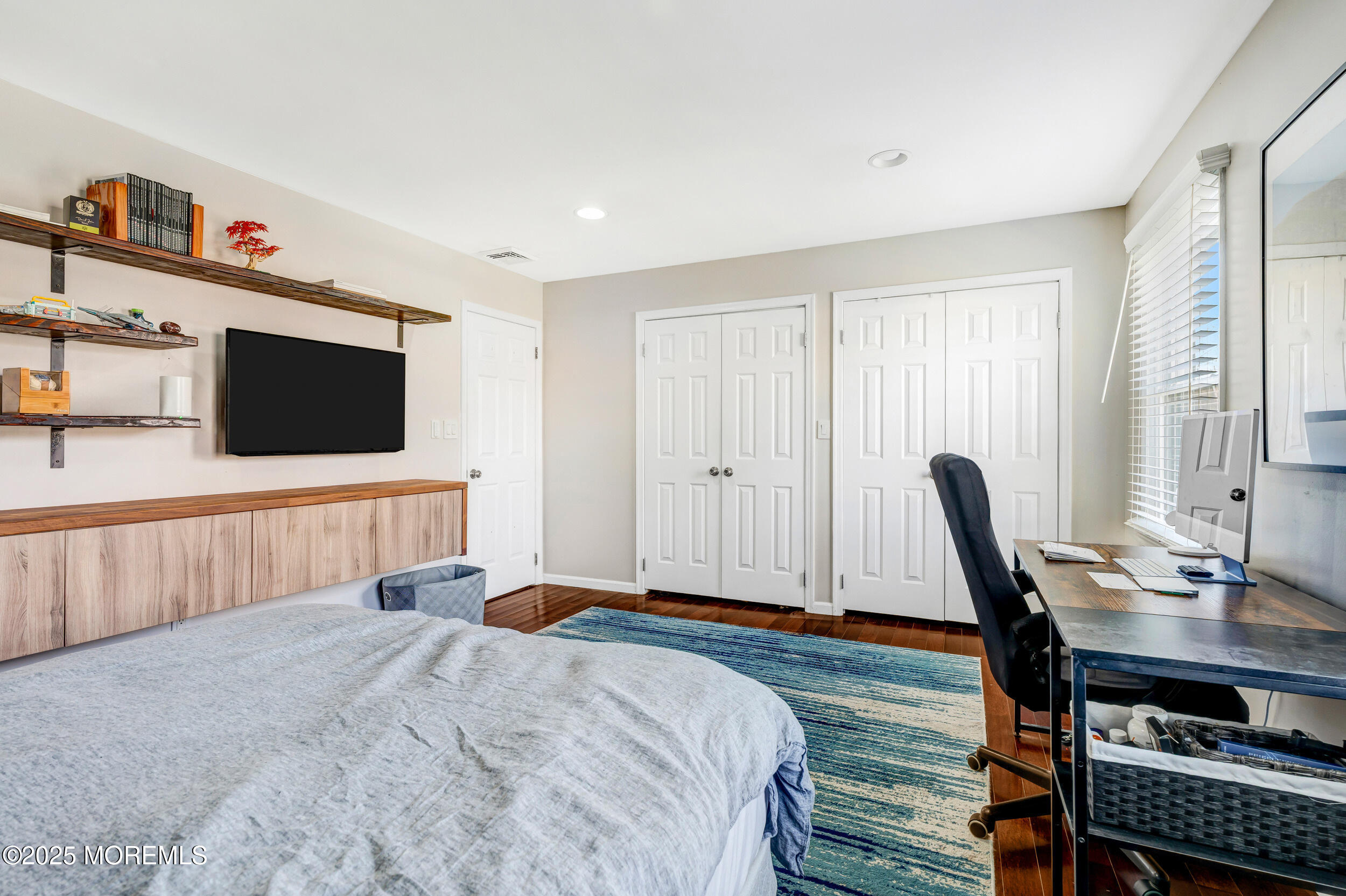 7 Oak Tree Lane Asbury Park, NJ 07712 - Photo 33 of 45 a bedroom with a bed and a flat screen tv