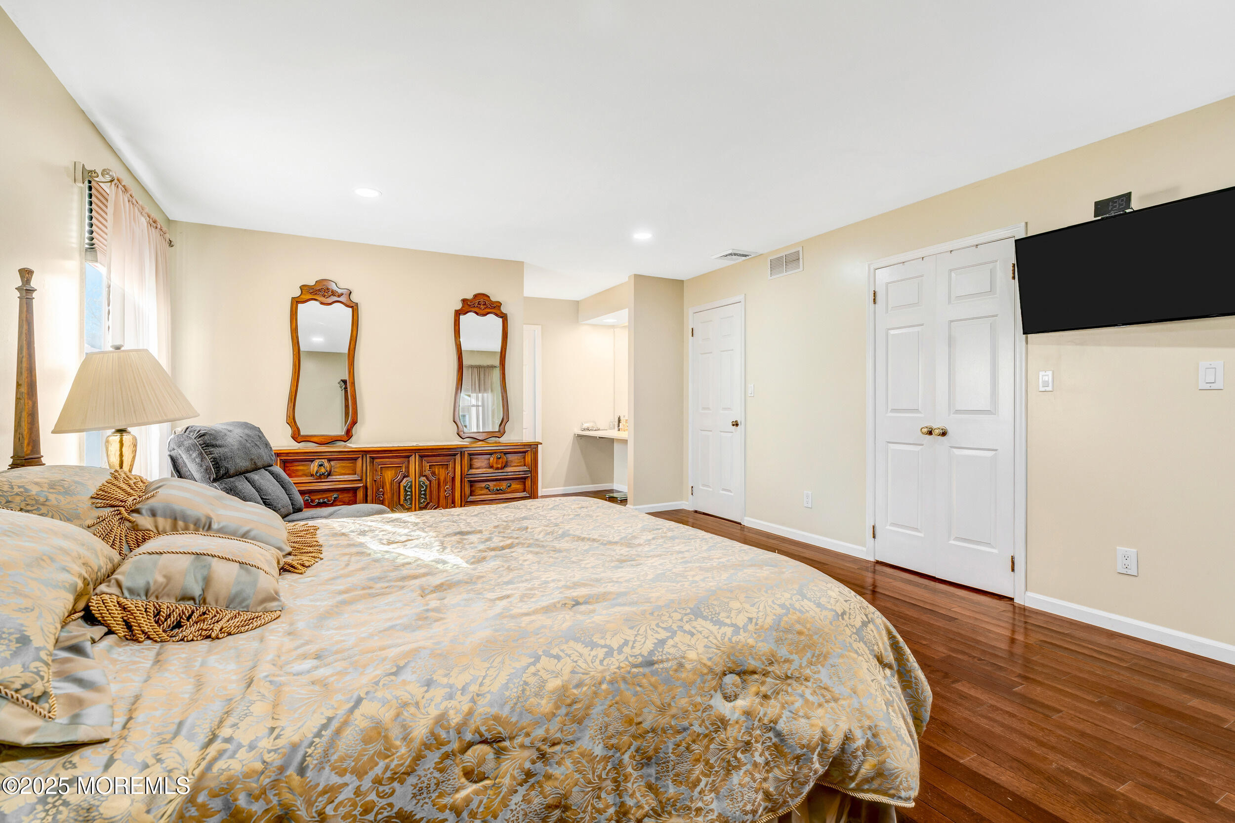 7 Oak Tree Lane Asbury Park, NJ 07712 - Photo 35 of 45 a bed room with a bed and a flat tv screen