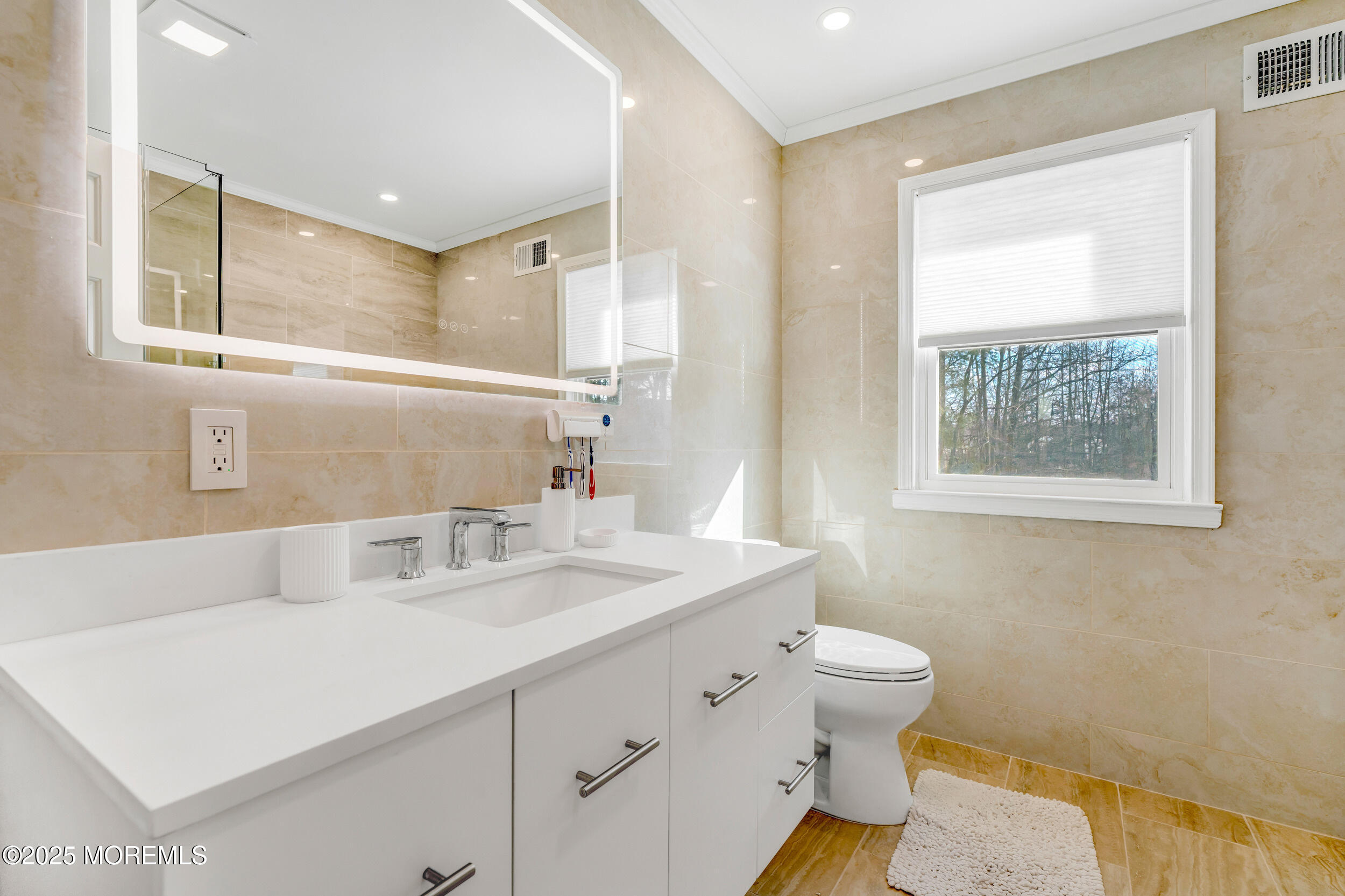7 Oak Tree Lane Asbury Park, NJ 07712 - Photo 37 of 45 a bathroom with a sink a toilet and a mirror