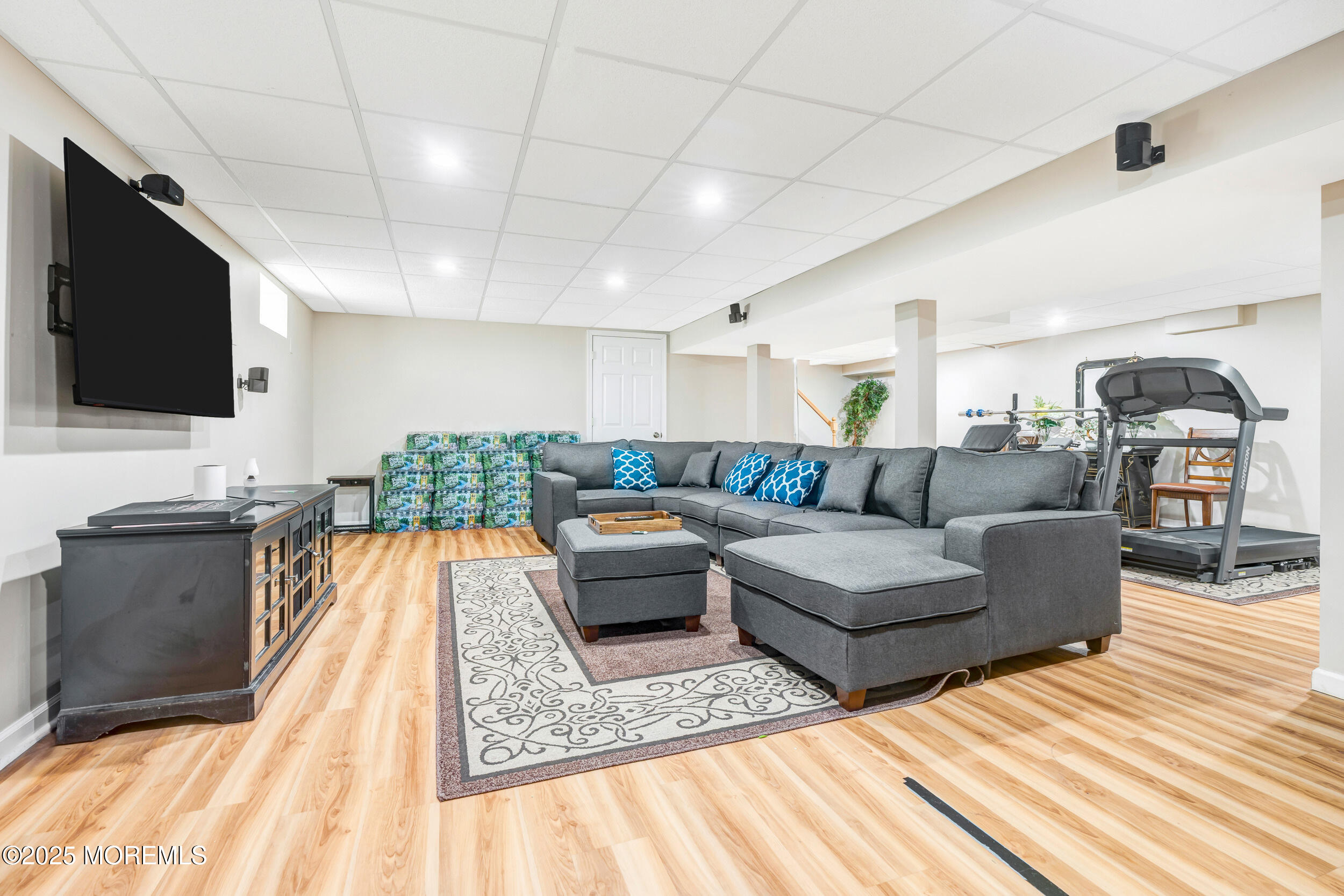7 Oak Tree Lane Asbury Park, NJ 07712 - Photo 40 of 45 a living room with couches a flat screen tv and kitchen view