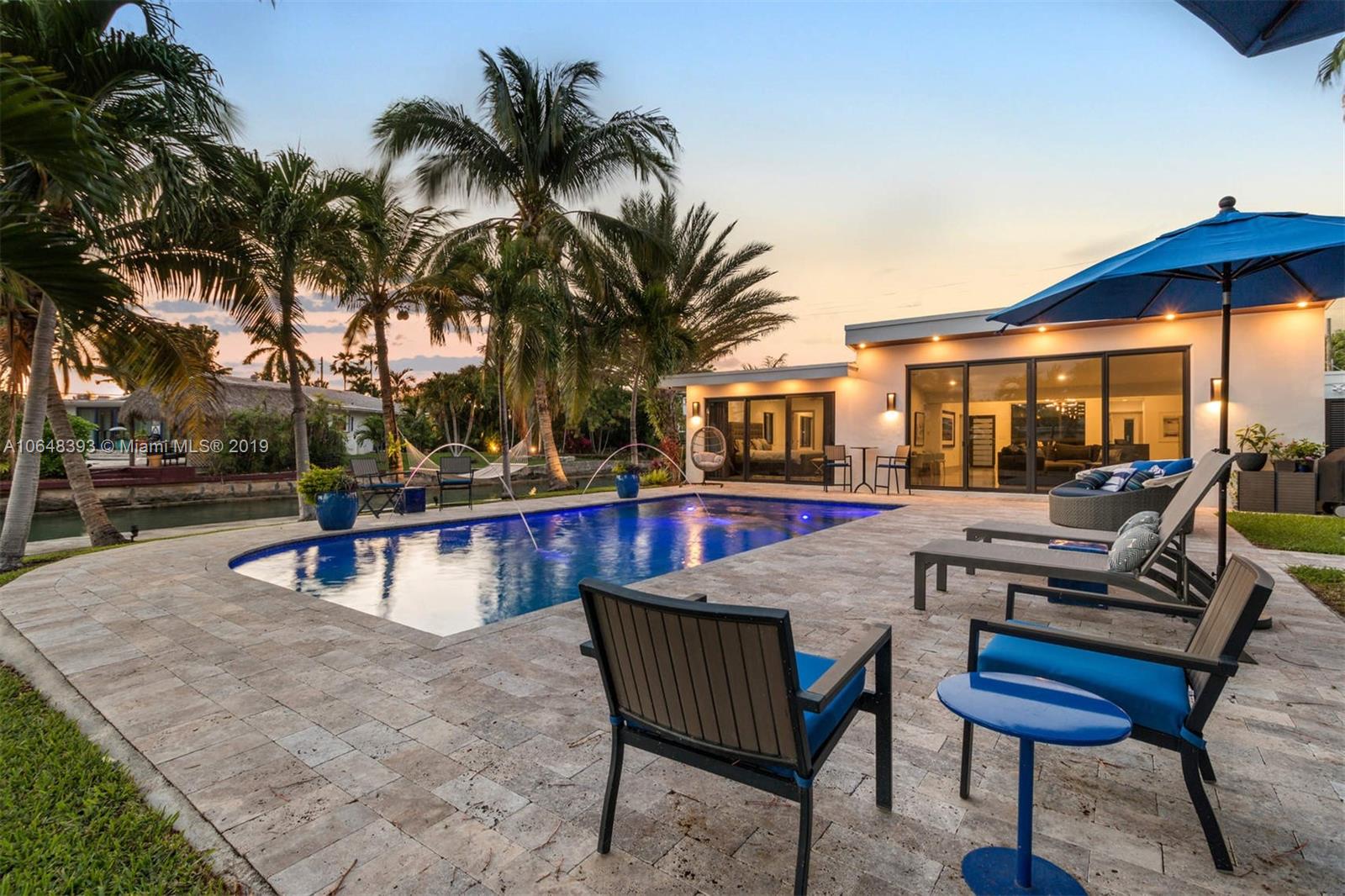 a view of a house with swimming pool and sitting area