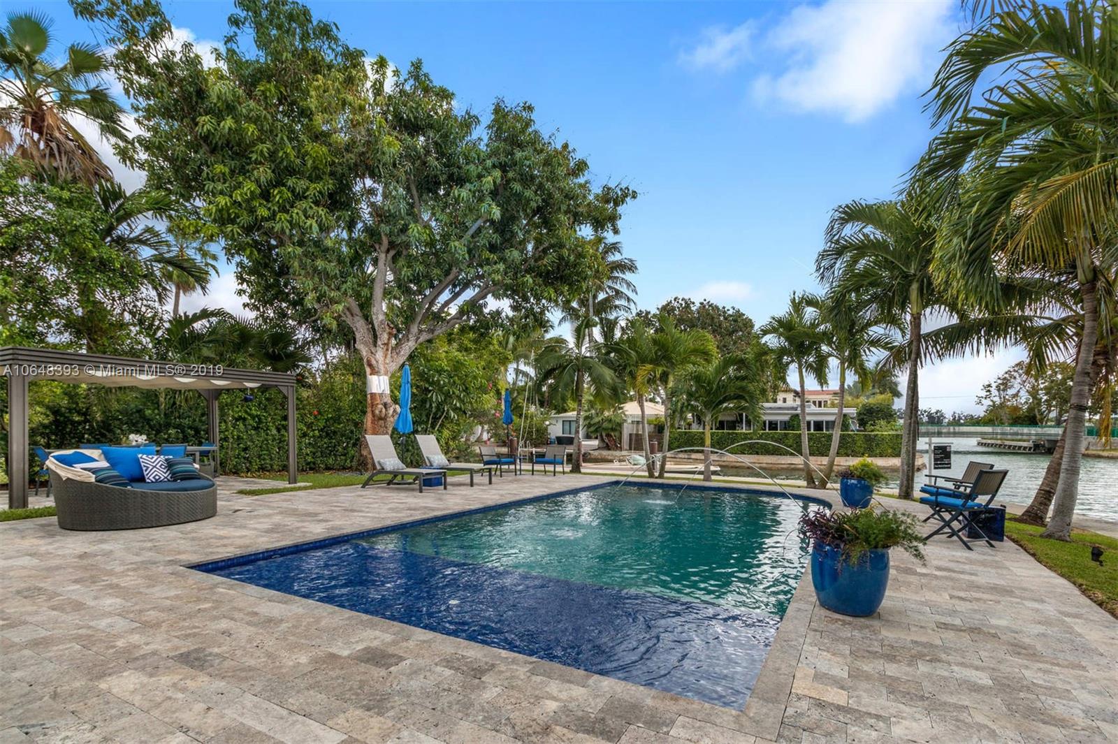 1880 Cleveland Road Miami Beach, FL 33141 - Photo 9 of 26 a view of a swimming pool with outdoor seating and plants