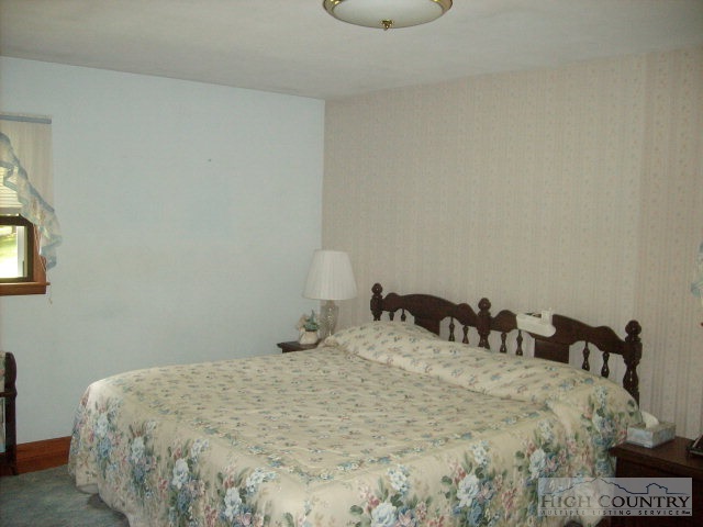 2195 Deerfield Road Boone, NC 28607 - Photo 17 of 19 a bedroom with a bed and a night stand