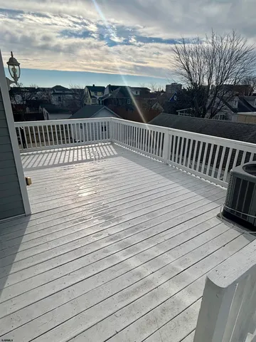 a view of a chairs and table on the roof deck