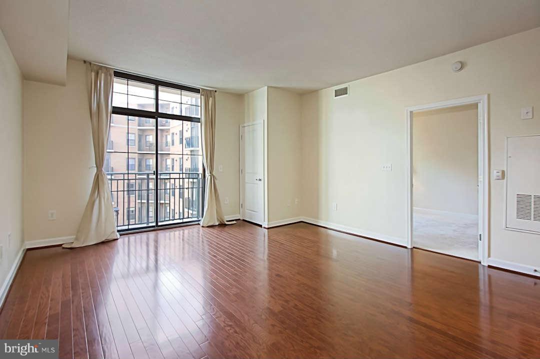 1111 25th Street Northwest, Unit 714 Washington, DC 20037 - Photo 11 of 28 an empty room with wooden floor and windows