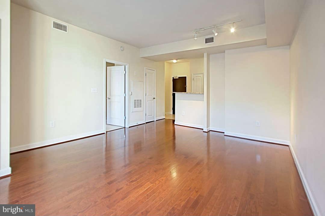 1111 25th Street Northwest, Unit 714 Washington, DC 20037 - Photo 13 of 28 a view of empty room with wooden floor