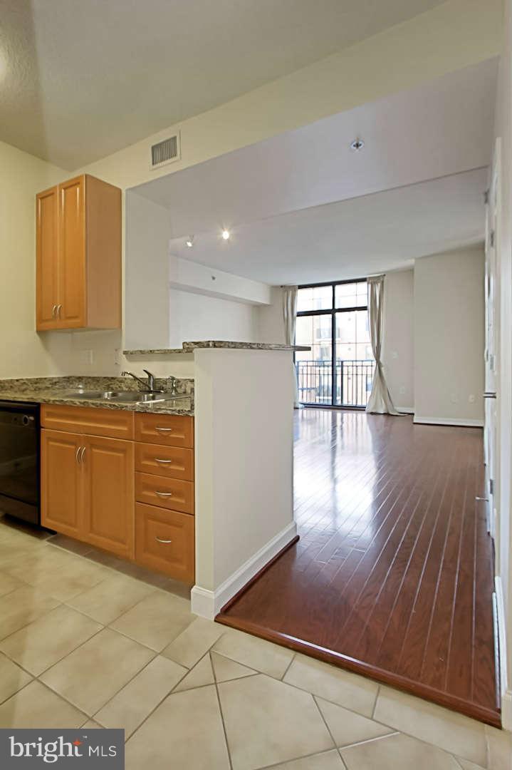 1111 25th Street Northwest, Unit 714 Washington, DC 20037 - Photo 8 of 28 a kitchen with stainless steel appliances granite countertop a stove a sink and a refrigerator