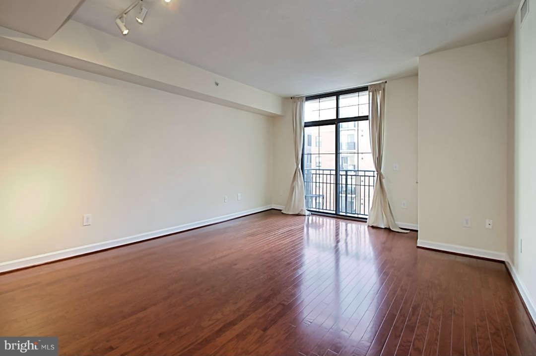 1111 25th Street Northwest, Unit 714 Washington, DC 20037 - Photo 10 of 28 a view of an empty room with wooden floor and a window