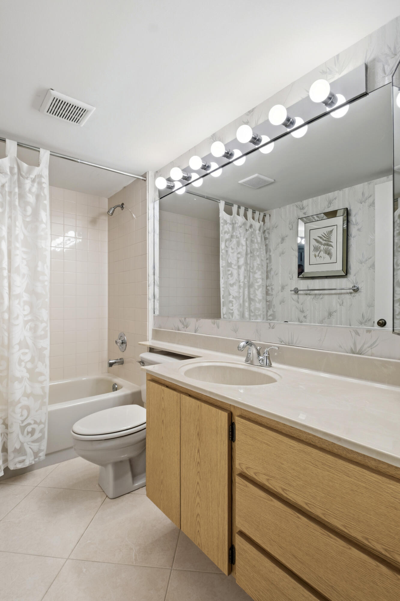 6145 Balboa Circle, Unit 103 Boca Raton, FL 33433 - Photo 21 of 31 a bathroom with a sink a toilet a large mirror and shower