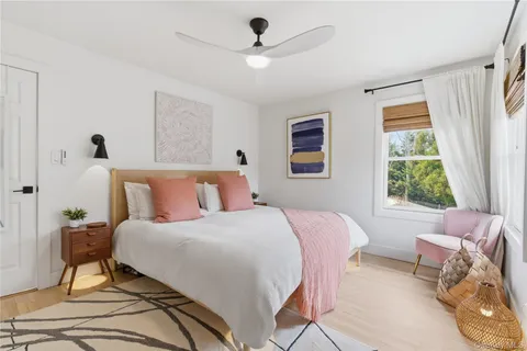 a bedroom with a bed and a painting on the wall