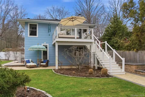 a view of a house with backyard sitting area and garden
