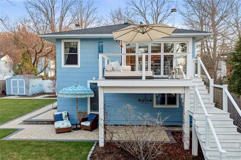 a view of a house with backyard and sitting area