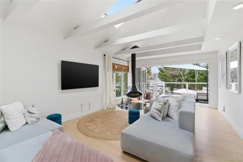 a kitchen with a large window and a view of living room