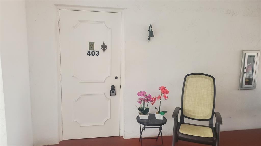 3910 Crystal Lake Drive, Unit 403 Deerfield Beach, FL 33064 - Photo 13 of 27 a view of a hallway with paintings on the wall