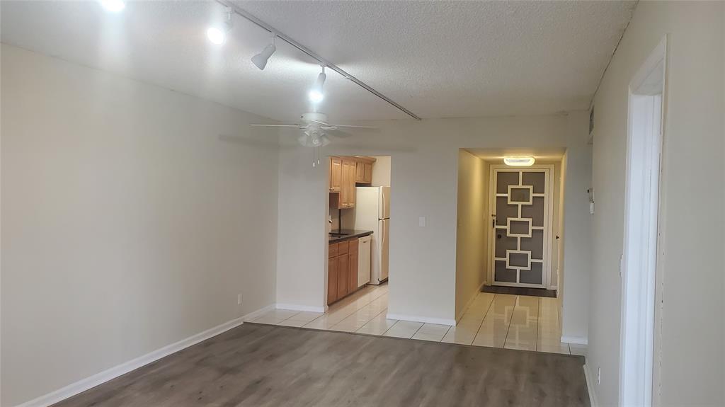 3910 Crystal Lake Drive, Unit 403 Deerfield Beach, FL 33064 - Photo 19 of 27 an empty room with wooden floor and entrance