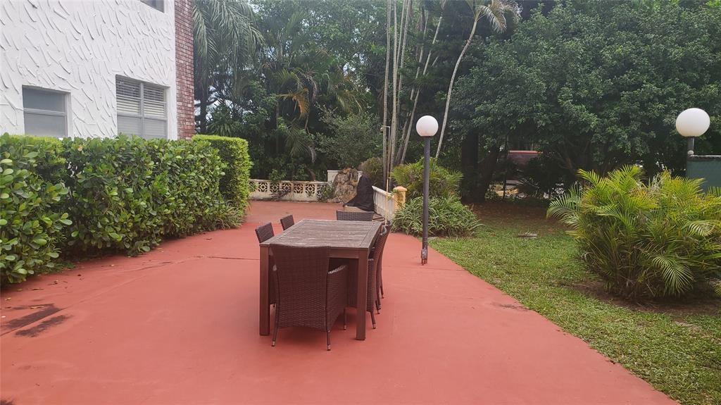 3910 Crystal Lake Drive, Unit 403 Deerfield Beach, FL 33064 - Photo 3 of 27 a backyard of a house with outdoor seating