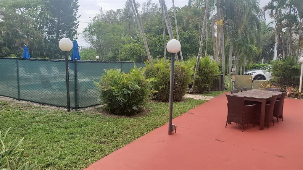 3910 Crystal Lake Drive, Unit 403 Deerfield Beach, FL 33064 - Photo 4 of 27 a view of a backyard with a garden and entertaining space
