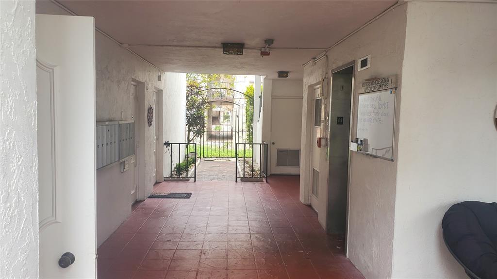 3910 Crystal Lake Drive, Unit 403 Deerfield Beach, FL 33064 - Photo 7 of 27 a view of a hallway with windows and a shower