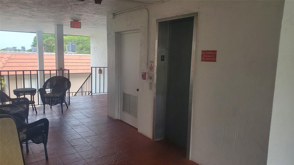 3910 Crystal Lake Drive, Unit 403 Deerfield Beach, FL 33064 - Photo 10 of 27 a dining room with furniture window wooden floor and glass door